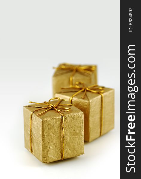 Three golden gift boxes