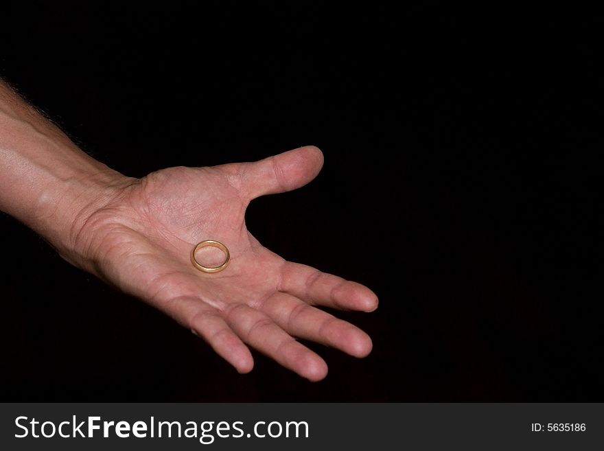 Hand of man returning wedding ring. Hand of man returning wedding ring