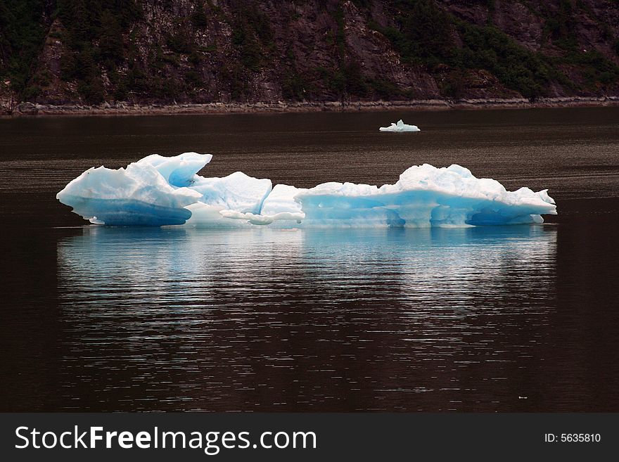 Blue iceberg in Alaska on the water