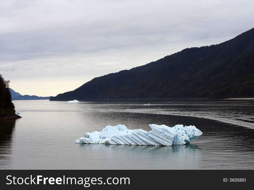 Blue iceberg in Alaska on the water