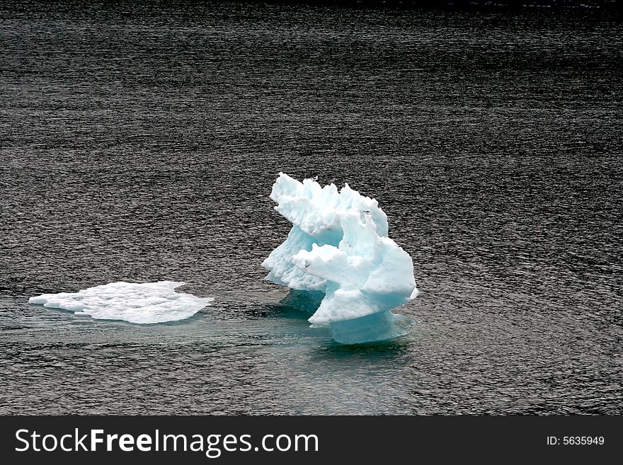 Blue iceberg in Alaska on the water
