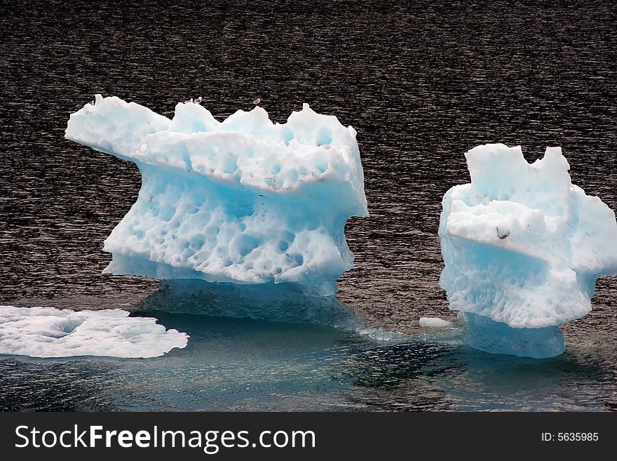 Blue iceberg in Alaska on the water