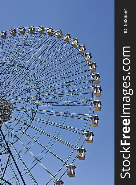 Ferris wheel with blue sky background.