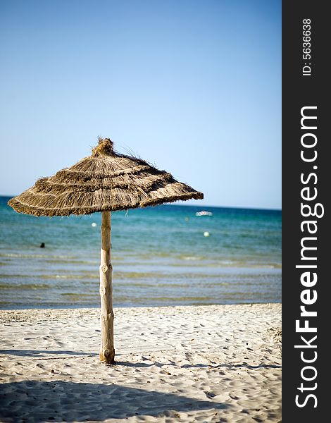 Beach in Tunisia with straw umbrella