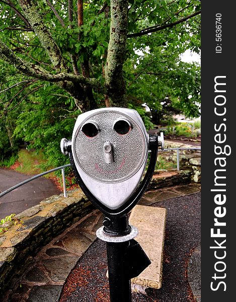 A coin operated binocular for viewing a landscape - face shaped. A coin operated binocular for viewing a landscape - face shaped.