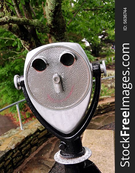 A coin operated binocular for viewing a landscape - face shaped. A coin operated binocular for viewing a landscape - face shaped.