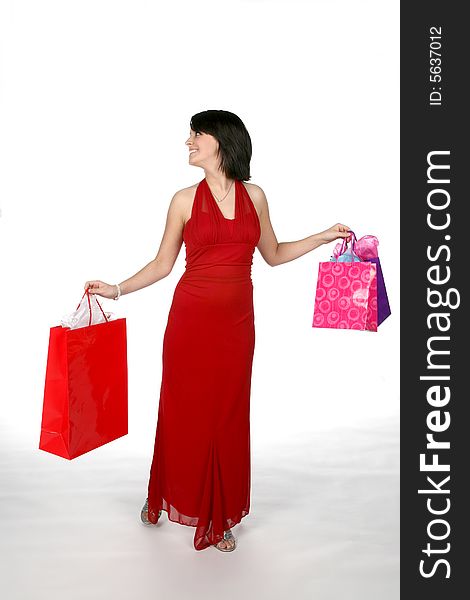 Pretty teen wearing a red gown and carrying shopping bags. Pretty teen wearing a red gown and carrying shopping bags