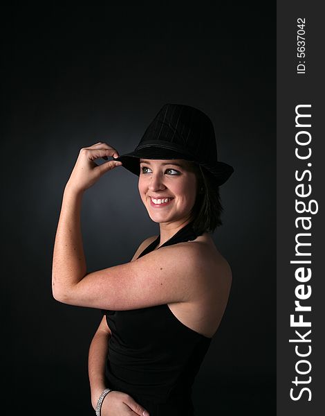 Cute teen in black dress and hat