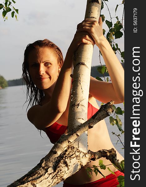 Woman Smile by Tree and Leaves in Water. Woman Smile by Tree and Leaves in Water