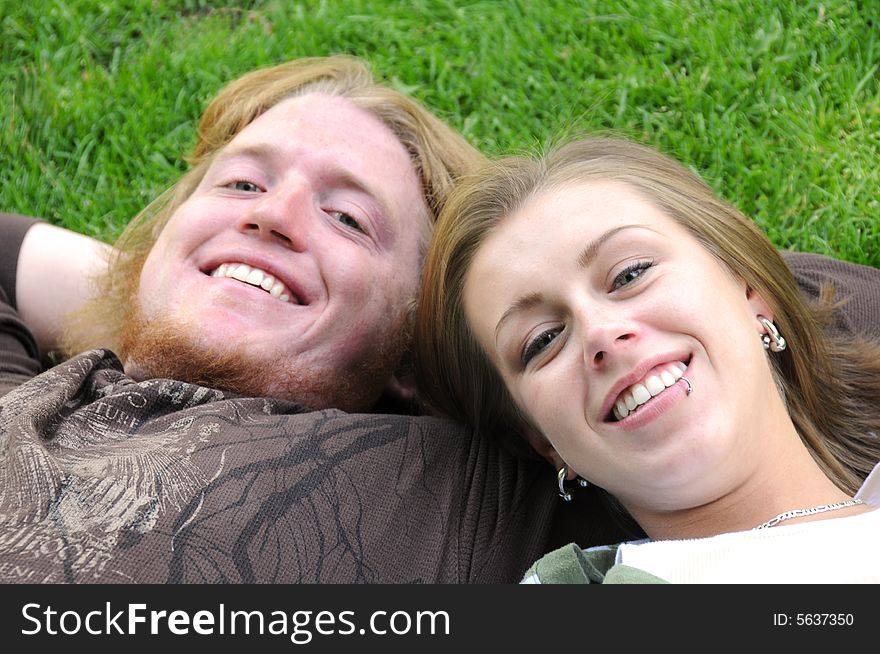 Young man and woman laying on the grass. Young man and woman laying on the grass