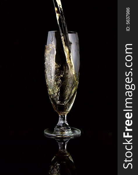 Glass of drink poured on black background. Glass of drink poured on black background