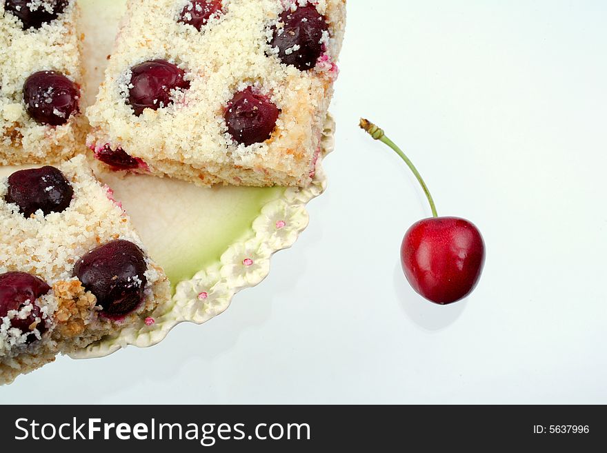 Homemade shortcake with cherry on white background. Homemade shortcake with cherry on white background