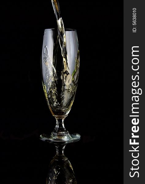 Glass of drink poured on black background. Glass of drink poured on black background