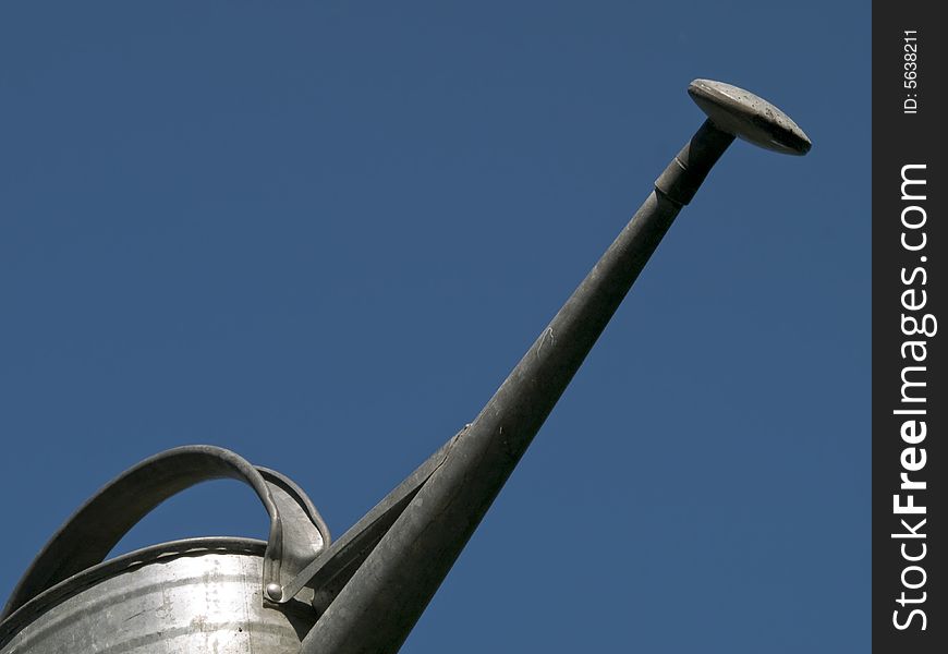 Ewer with a long caster in front of bue sky