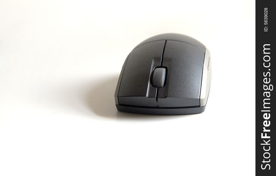 A wireless computer mouse on white.