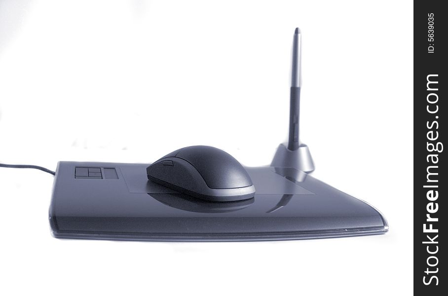 A wireless computer mouse on white with a pen and tablet. Has a slight blue color cast. A wireless computer mouse on white with a pen and tablet. Has a slight blue color cast.