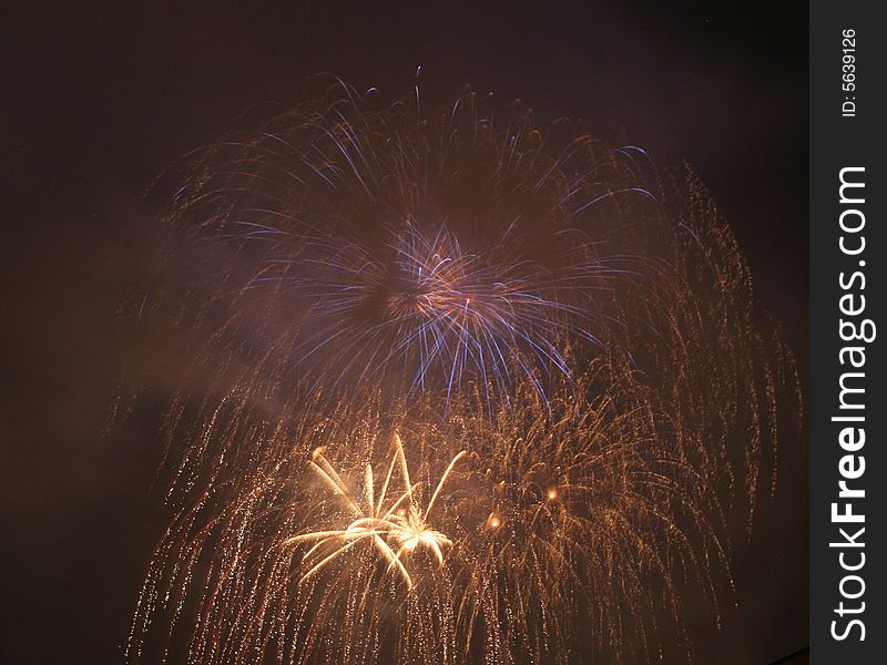 Saluting in front of a red, white, and blue fireworks display. Saluting in front of a red, white, and blue fireworks display