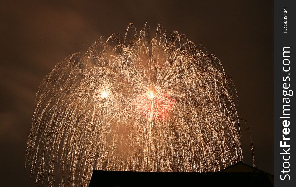 Saluting in front of a red, white, and blue fireworks display. Saluting in front of a red, white, and blue fireworks display