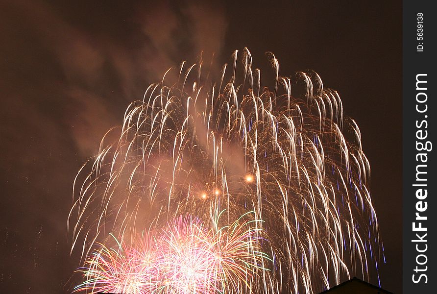 Saluting in front of a red, white, and blue fireworks display. Saluting in front of a red, white, and blue fireworks display