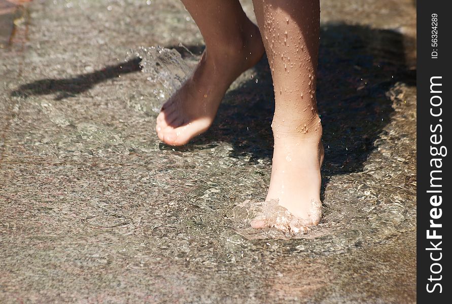 Girl S Feet Playing In The Fountain