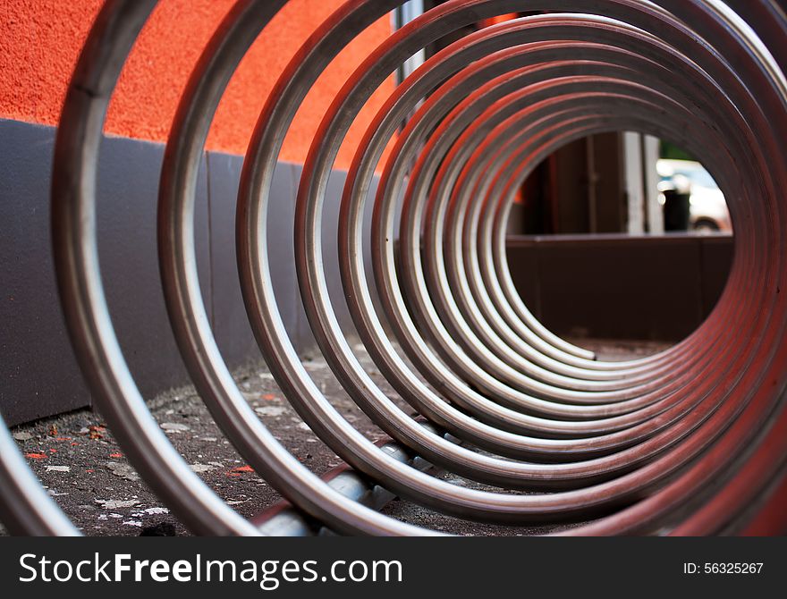 Fragment of large metal spiral as an abstract background outside closeup. Fragment of large metal spiral as an abstract background outside closeup