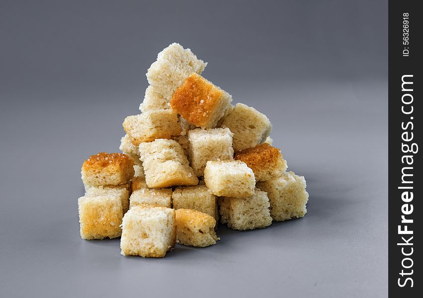 Pyramid Made Of Croutons Isolated On Grey