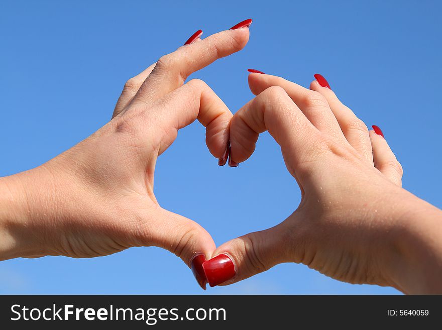 Lady makes shape of hearts with here hands. Lady makes shape of hearts with here hands