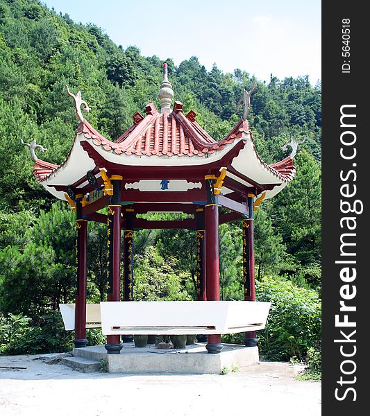 Chinese style summerhouse  besides the mountain.