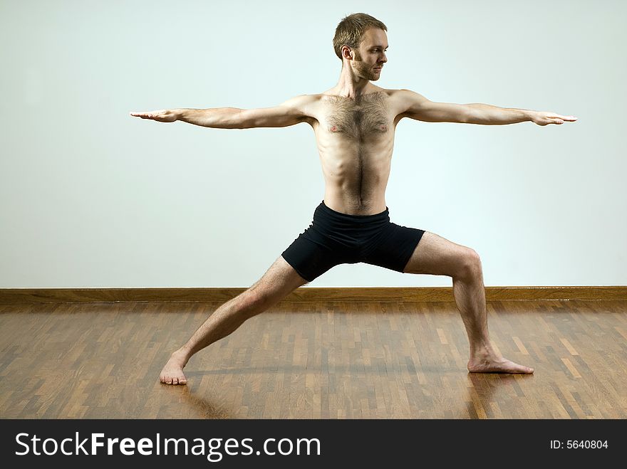 Man practicing yoga with his arms outstretched. Horizontally framed photograph. Man practicing yoga with his arms outstretched. Horizontally framed photograph