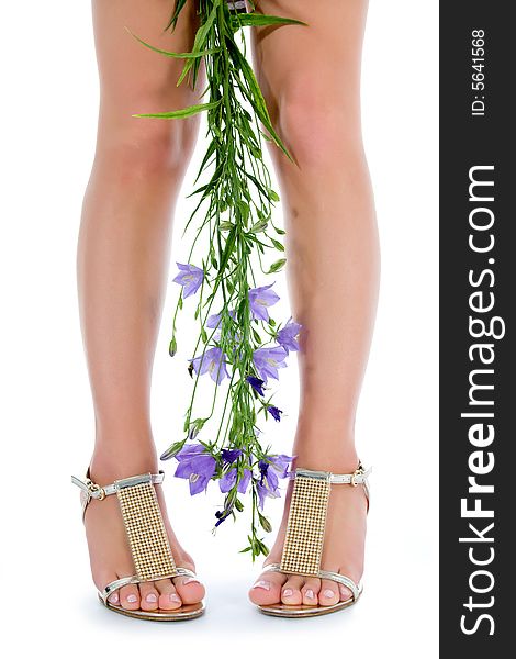 Long legs on high heels with flowers on white