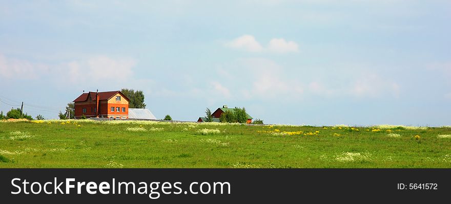 Small house in the distance on a meadow. Small house in the distance on a meadow