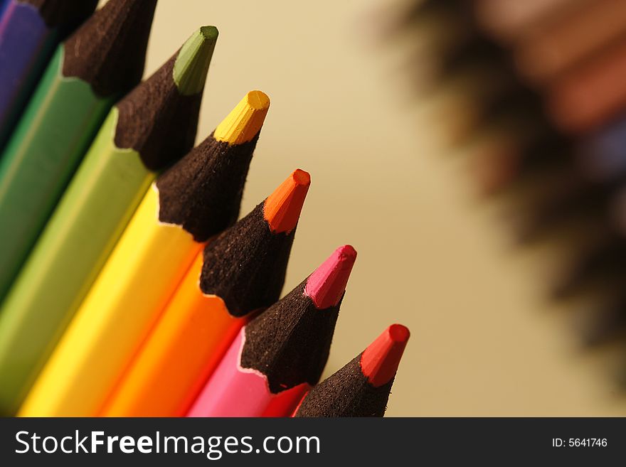 Colurs pencils in a simple colorful background