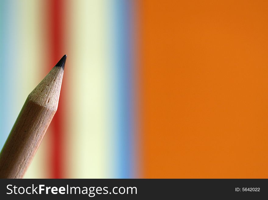 A pencil  with a simple colorful  background. A pencil  with a simple colorful  background