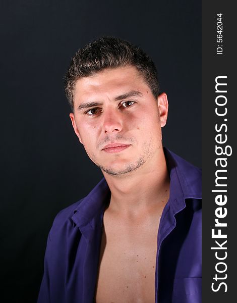 Male model in studio against a dark wall