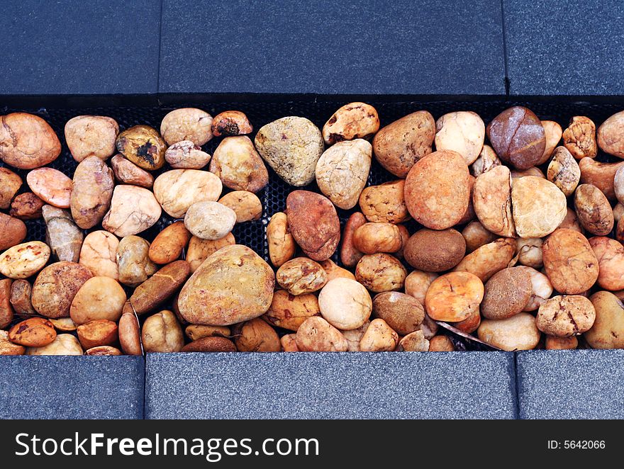 Close-up of brown stone pebbles in a garden.