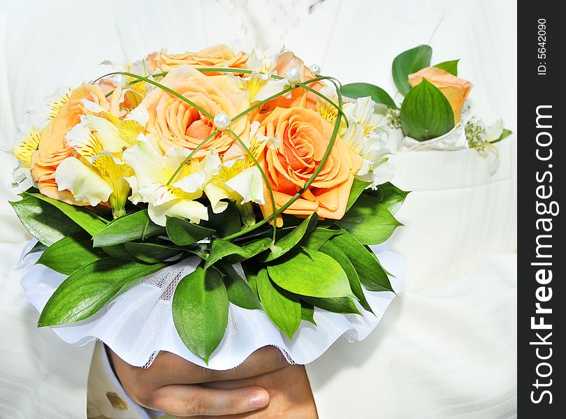 Groom in luxurious wedding suit with wedding bouquet. Groom in luxurious wedding suit with wedding bouquet