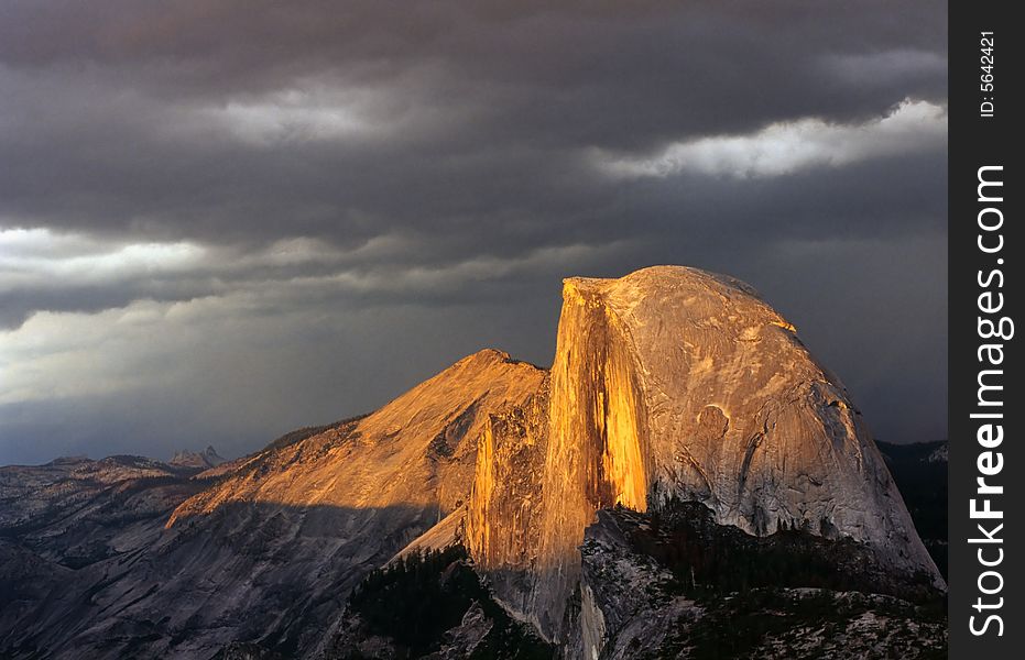 Half Doom under stormy Sunset, Yosemite National Park; It shined under the last ray of sunset while a summer storm approaching