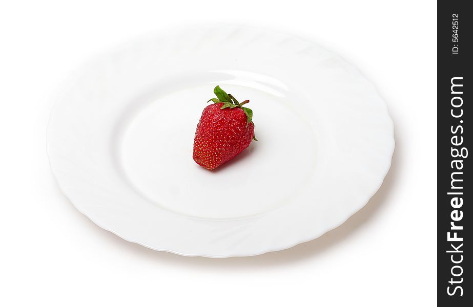 An appetizing strawberry on a white plate at the white background. An appetizing strawberry on a white plate at the white background