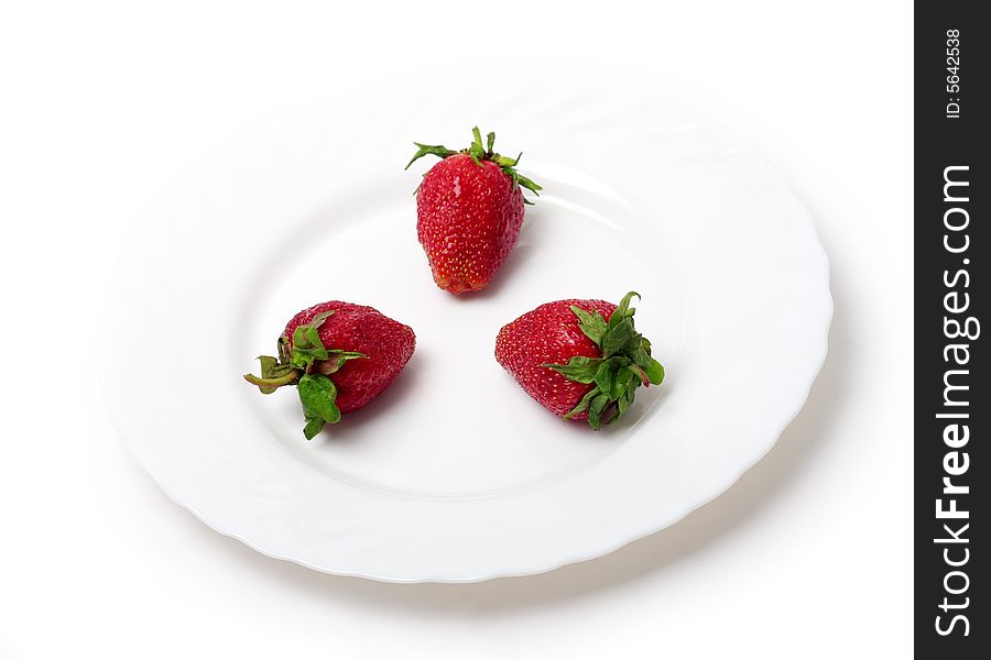 An appetizing strawberries on a white plate. An appetizing strawberries on a white plate