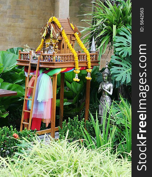 Offerings on a spirit house in Thailand - travel and tourism.