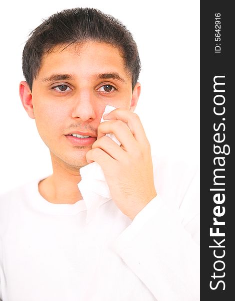 Close up of teenager wiping his tears away. isolated on white background. Close up of teenager wiping his tears away. isolated on white background