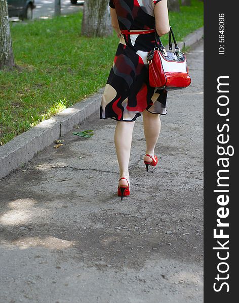Womanish feet, red shoes and bag