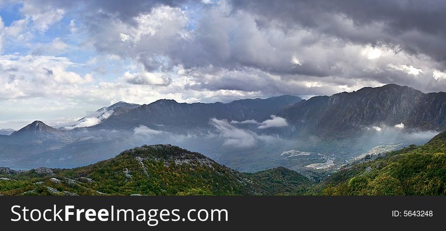 Panoramic view of autumn in mountains with dramatic sky