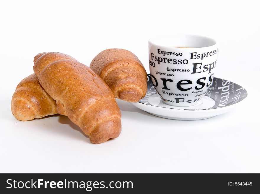 Cup of coffee with three croissants in white
