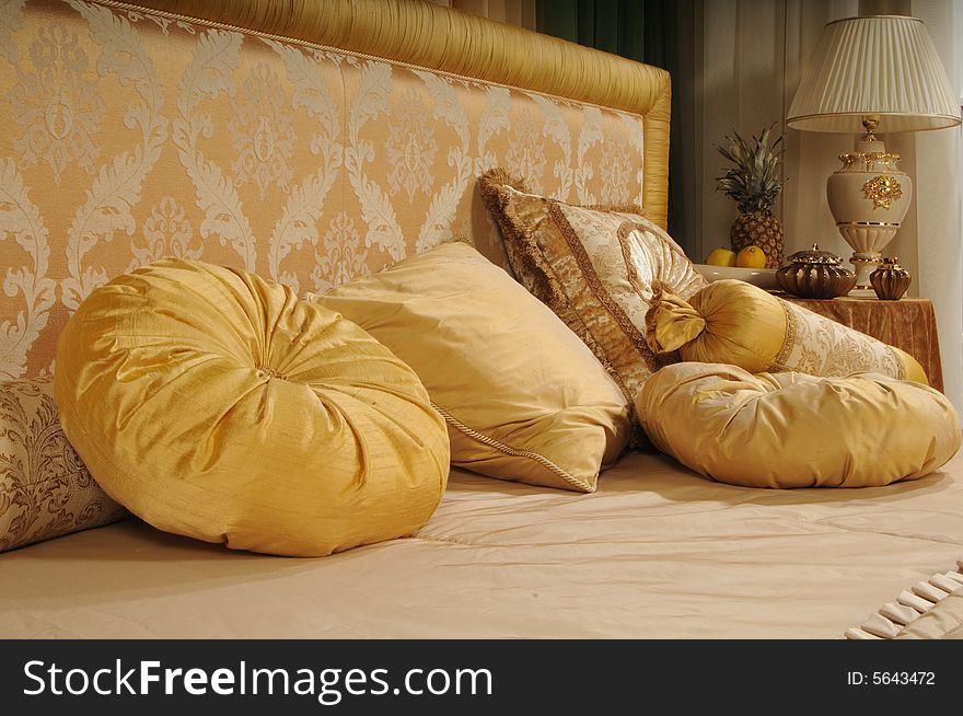 Decorative pillows on a bed at a headboard