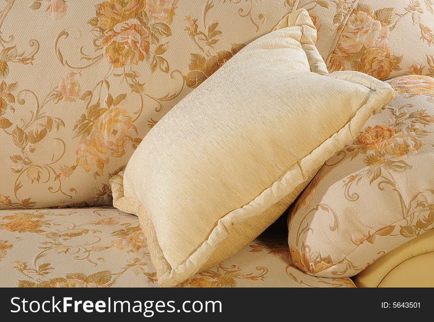 Close up a pillow laying on a sofa. Close up a pillow laying on a sofa