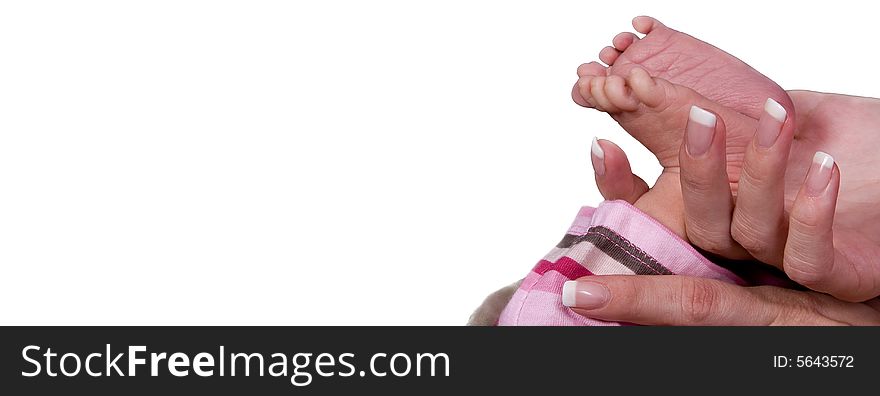 Baby feet held by mothers hand in front of white background