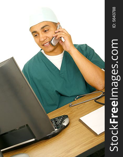 Isolated man on the phone and working at computer at the same time. concept for medical staff. Isolated man on the phone and working at computer at the same time. concept for medical staff