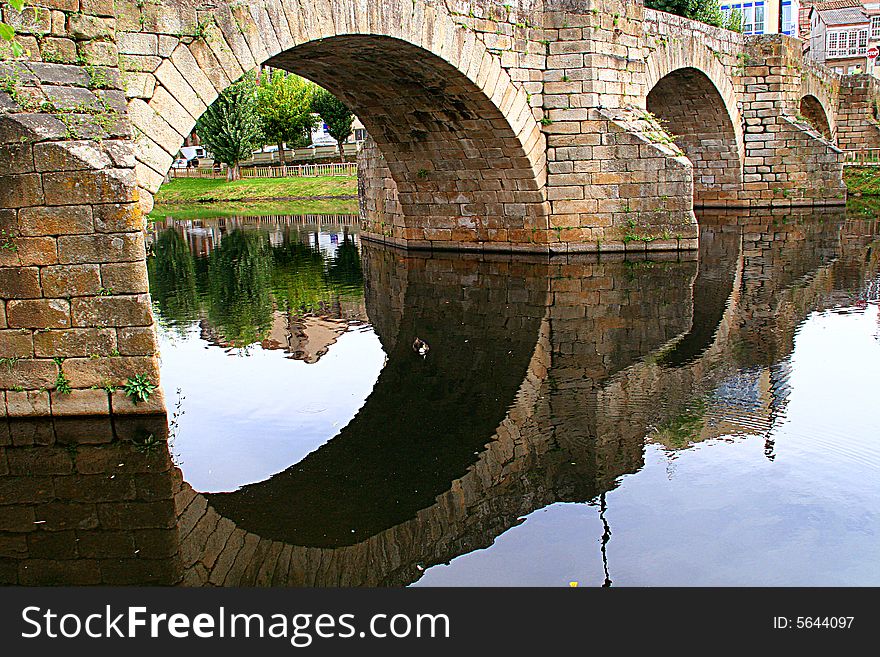 Old stone bridge on water