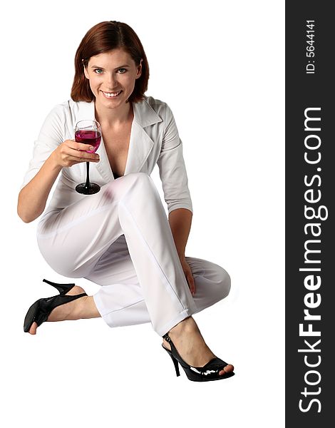 Business the woman in white clothes holds in a hand a glass with a bright drink. Business the woman in white clothes holds in a hand a glass with a bright drink